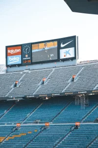 stadium bleachers with a wide screen monitor and a big clock